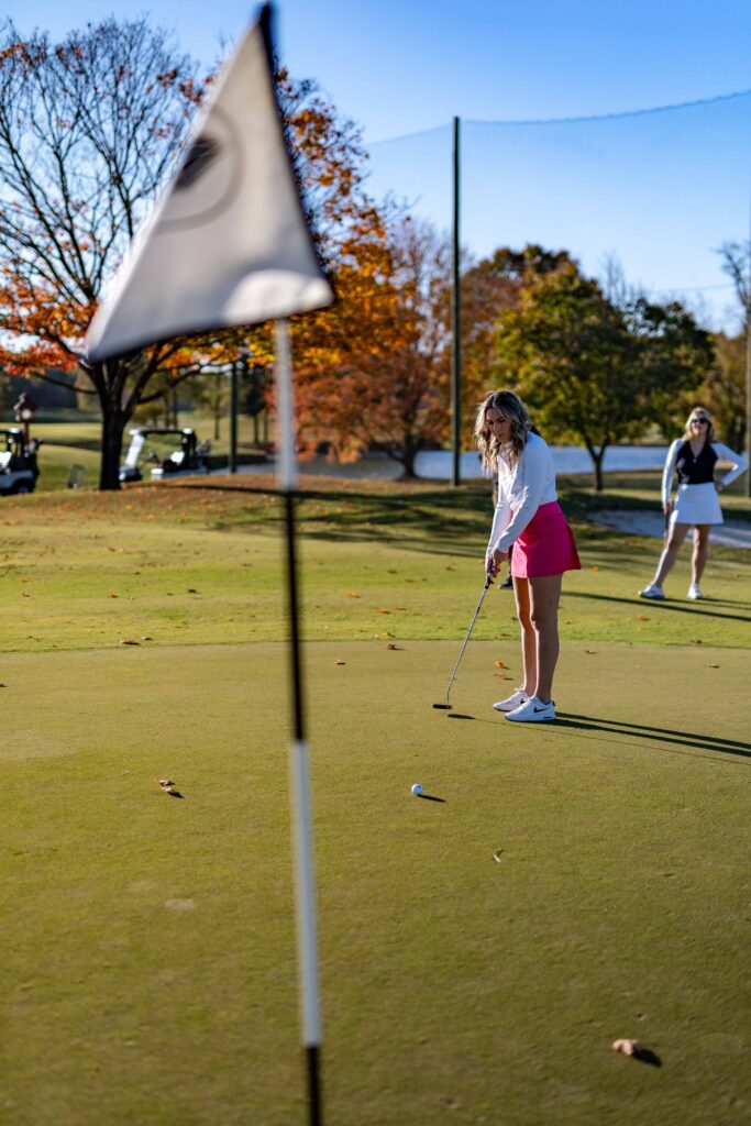 Woman at a putting green.